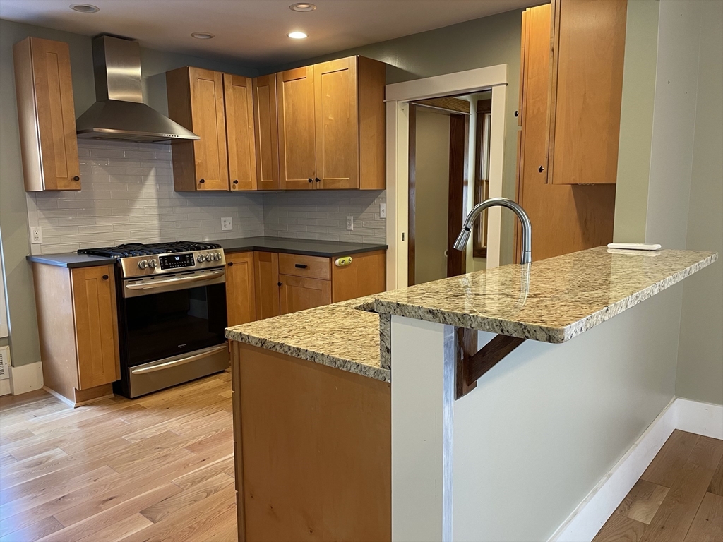 492 Elm Street Northampton, MA 01060 - Photo 15 of 31 a kitchen with stainless steel appliances granite countertop a sink stove and cabinets