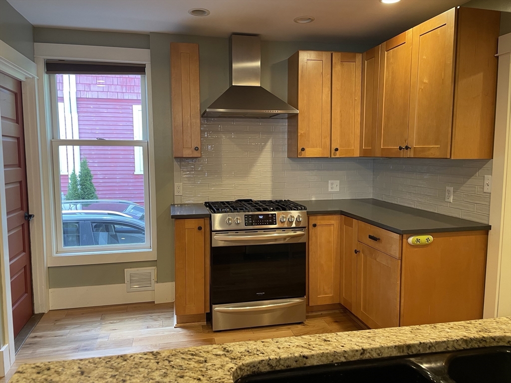 492 Elm Street Northampton, MA 01060 - Photo 16 of 31 a kitchen with stainless steel appliances granite countertop a stove a sink and a microwave