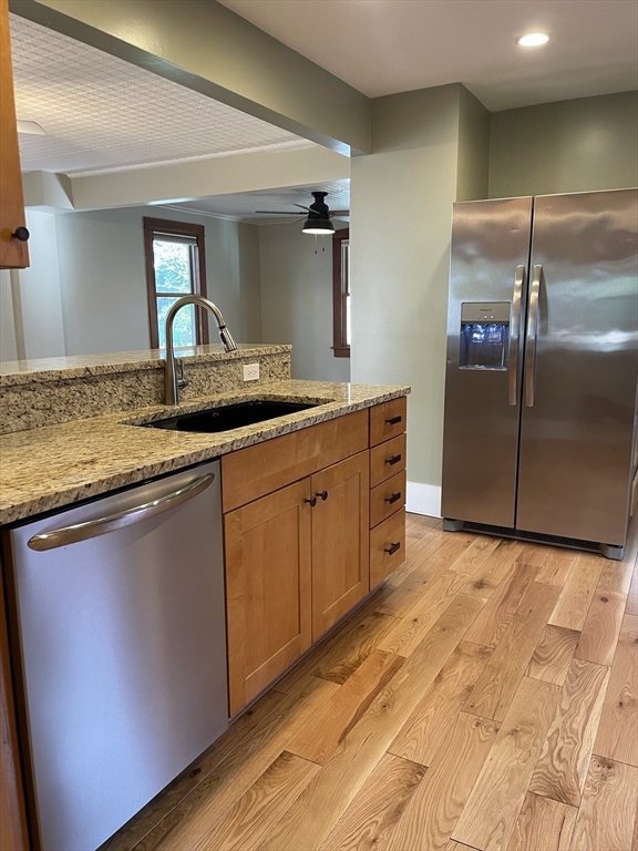 492 Elm Street Northampton, MA 01060 - Photo 18 of 31 a kitchen with stainless steel appliances granite countertop a sink and a refrigerator