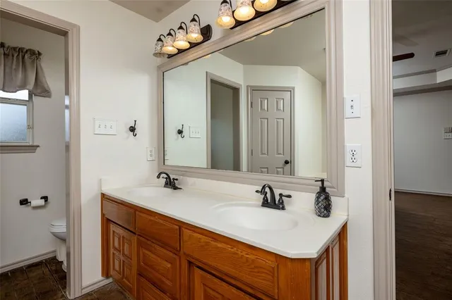 a bedroom with bed and wooden floor