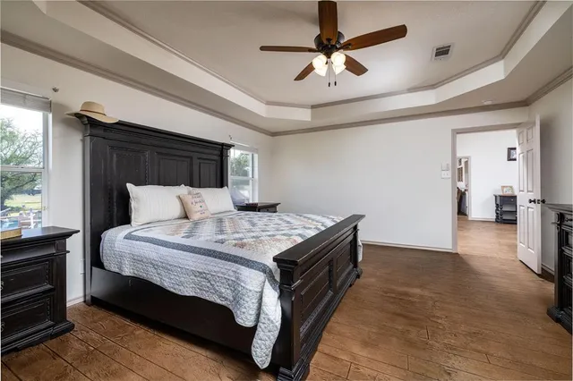 a bedroom with a bed and a chandelier