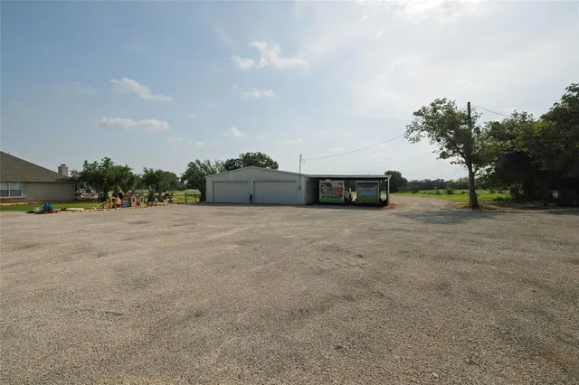 an aerial view of a house with outdoor space and sitting space