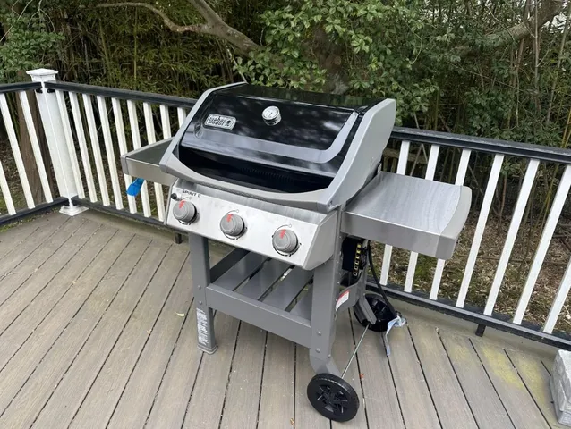 a view of a deck with wooden floor and fence with a floor to ceiling window
