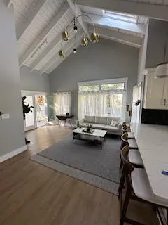 a living room with furniture and a chandelier