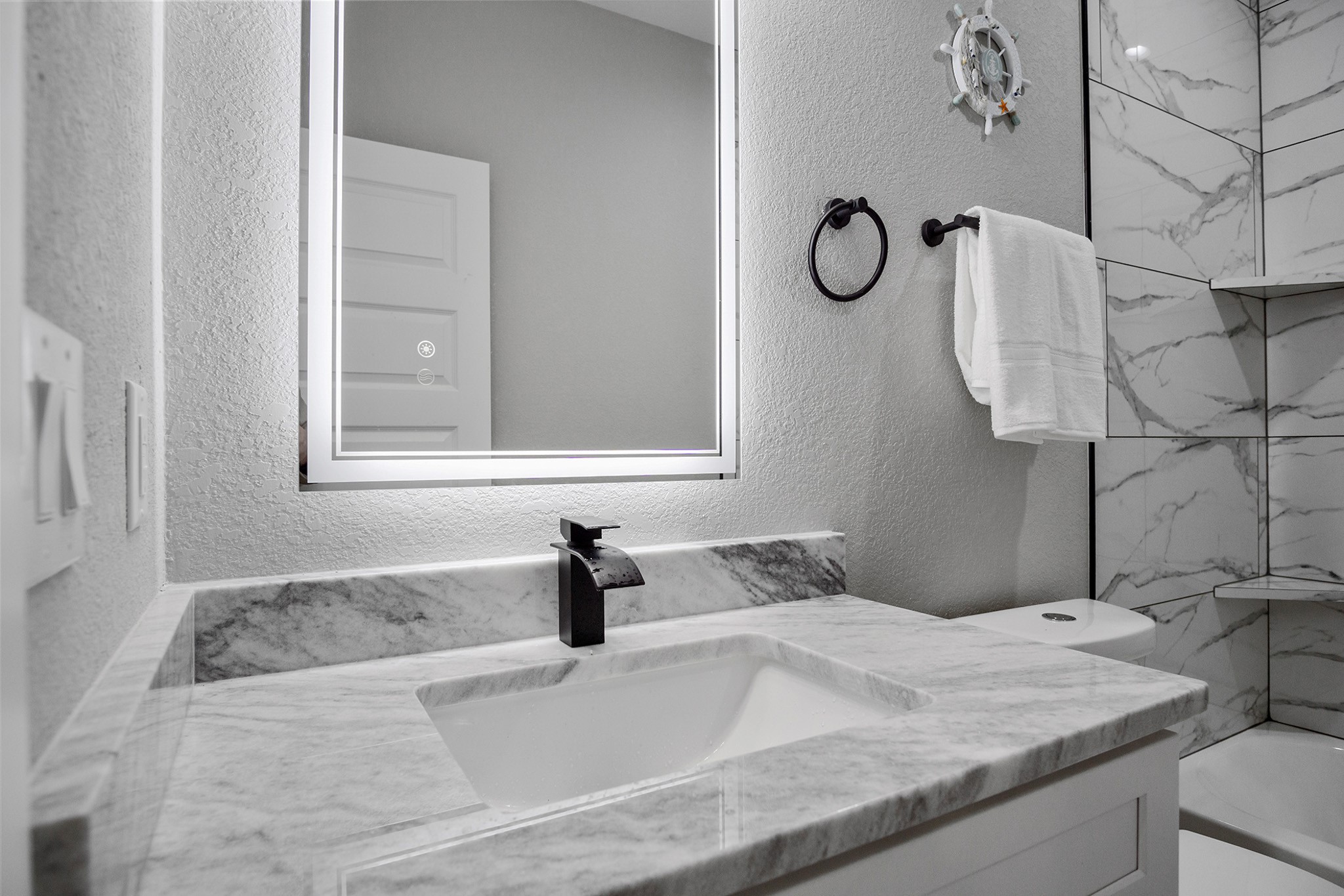 1297 Mabry Port Bolivar, TX 77650 - Photo 13 of 38 a bathroom with a granite countertop sink and a mirror