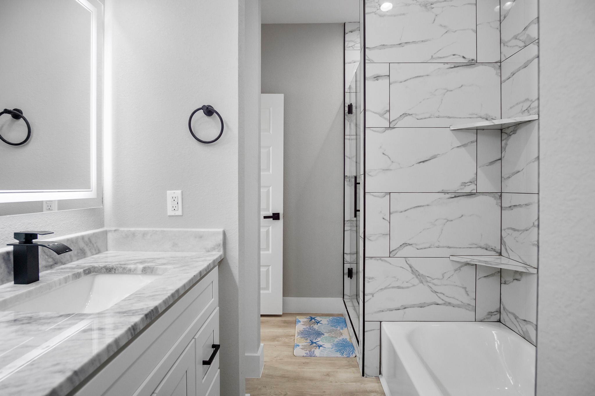 1297 Mabry Port Bolivar, TX 77650 - Photo 29 of 38 a bathroom with a granite countertop sink a mirror and a bathtub