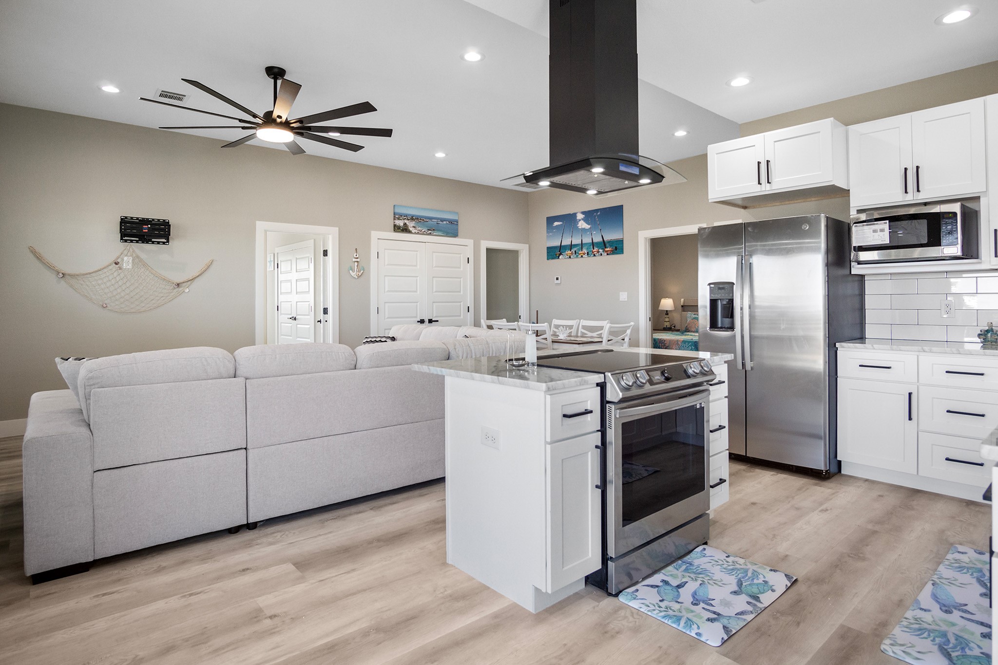 1297 Mabry Port Bolivar, TX 77650 - Photo 10 of 38 a kitchen with stainless steel appliances kitchen island granite countertop a refrigerator a sink a stove and white cabinets