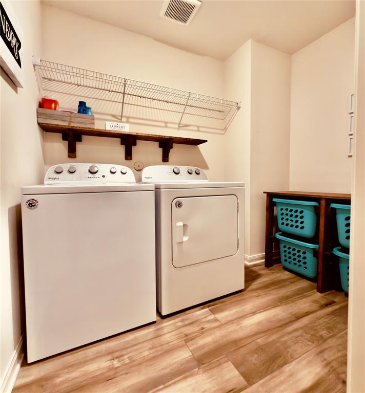 196 Cattlemans Crk Road West Newark, TX 76071 - Photo 17 of 24 Dedicated utility space featuring wood-finish flooring, a built-in wood shelf, and an overhead wire rack for storage