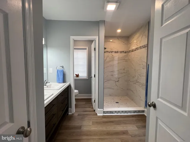 a en suite bathroom with a sink and mirror