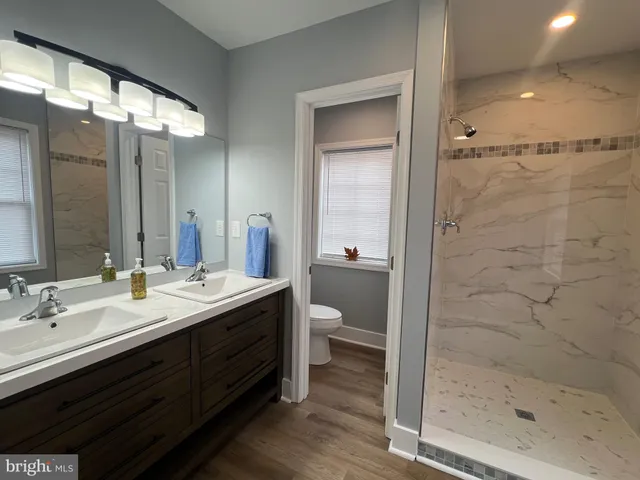a room with water heater and wooden cabinets