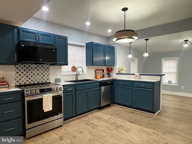 a kitchen with a sink and cabinets
