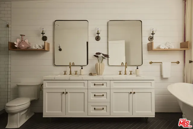 a spacious bathroom with a sink and a large mirror