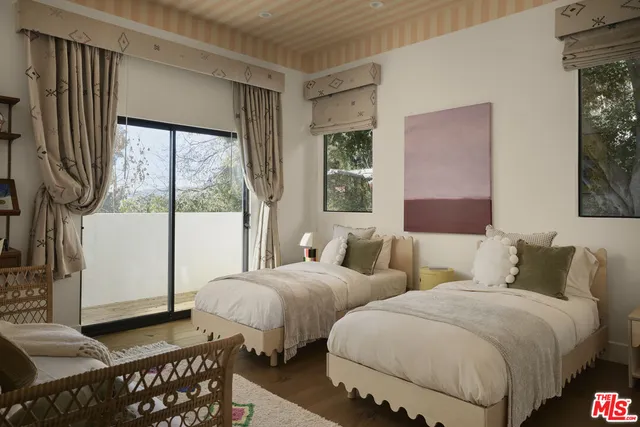 a bedroom with furniture and a painting on the wall