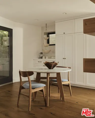 a bedroom with furniture and a large window