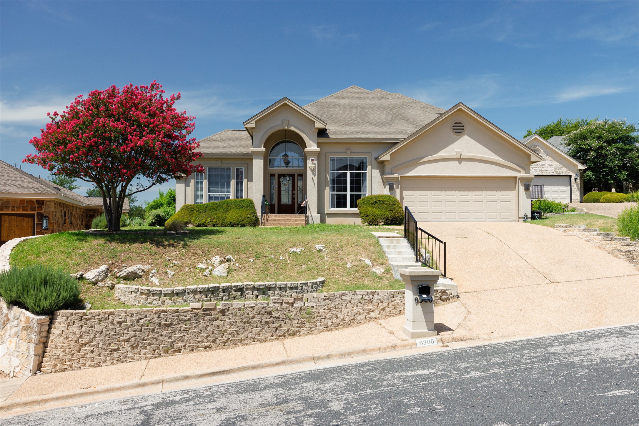 9300 Simmons Road Austin, TX 78759 - Photo 17 of 17 A graceful home with a welcoming arched entryway and a two-car garage awaits.