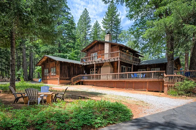 a view of a house with pool and sitting area