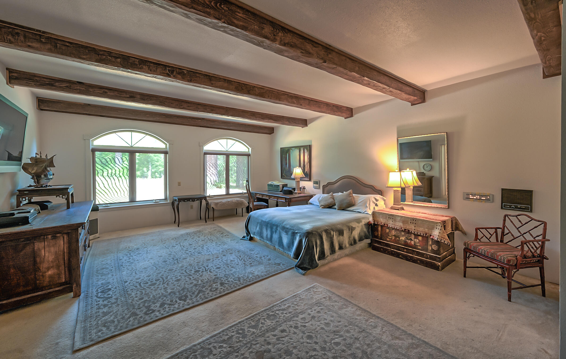 29230 Fenders Ferry Road Bella Vista, CA 96008 - Photo 23 of 60 a spacious bedroom with a bed a couch and a dresser next to a window