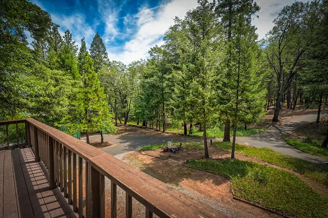 a front view of a house with a yard and trees