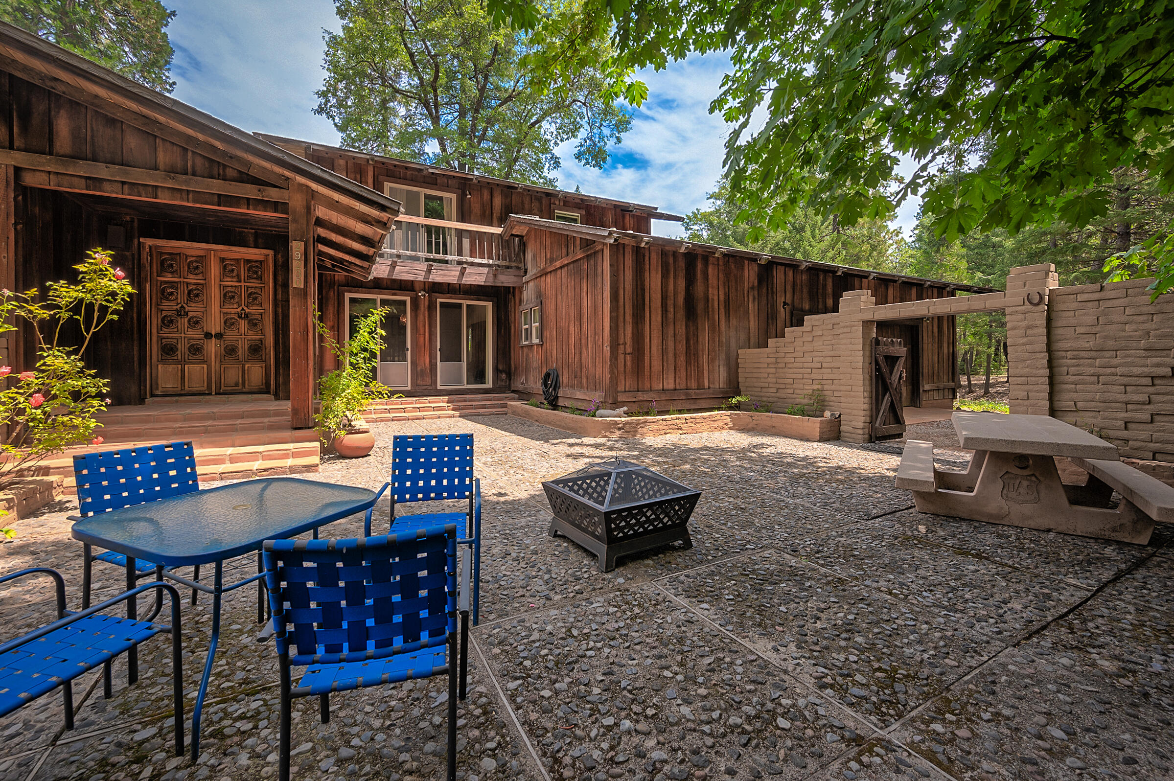29230 Fenders Ferry Road Bella Vista, CA 96008 - Photo 7 of 60 a backyard of a house with yard and outdoor seating