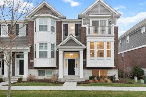 a front view of a residential apartment building with a yard