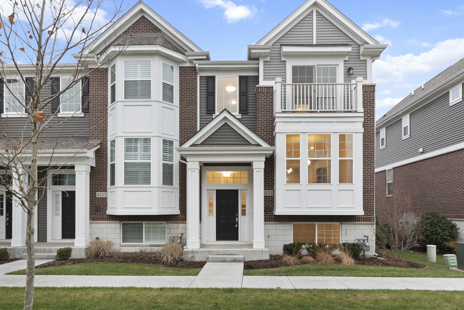 4431 Monroe Court Naperville, IL 60564 - Photo 1 of 13 a front view of a residential apartment building with a yard