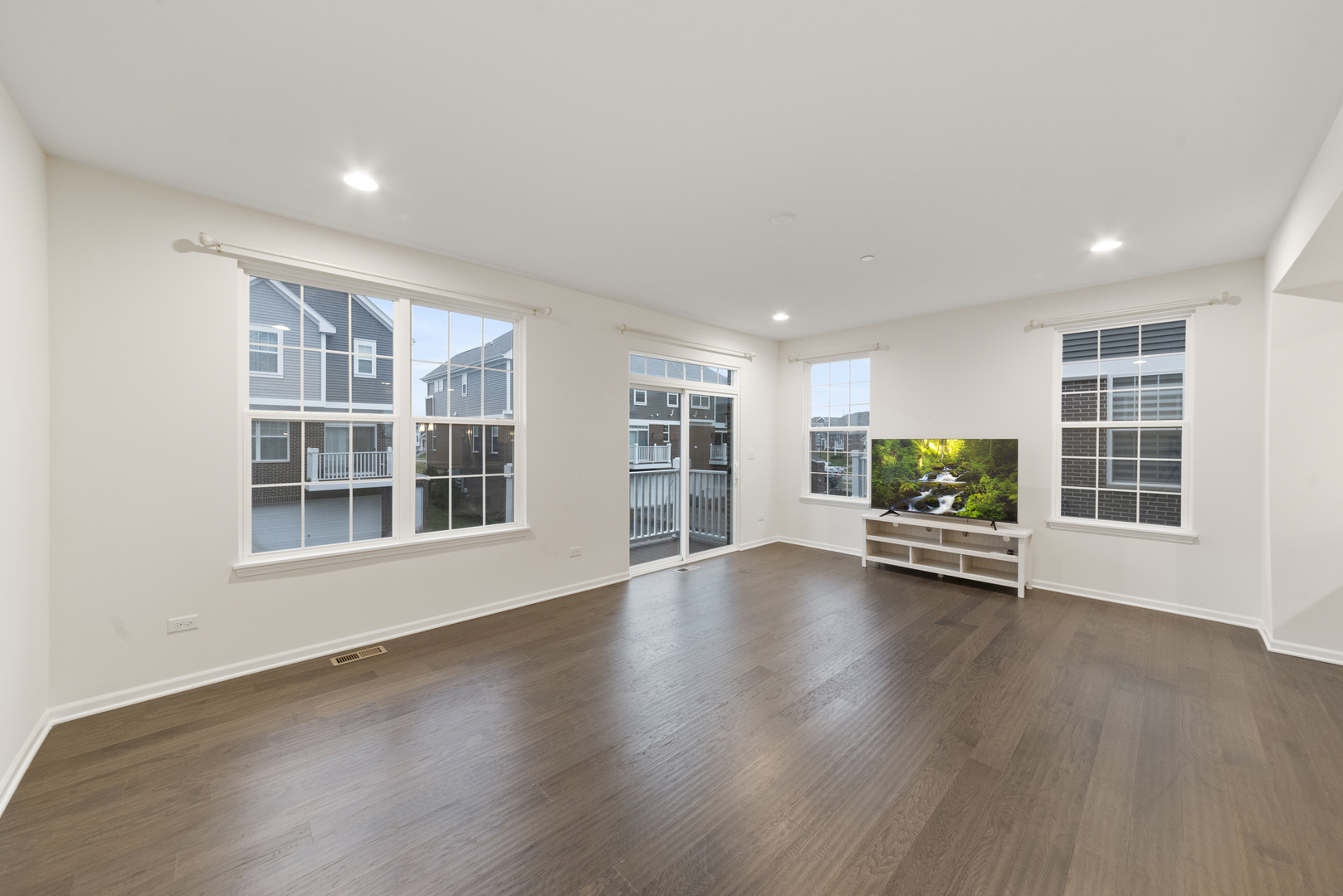 4431 Monroe Court Naperville, IL 60564 - Photo 4 of 13 a view of an empty room with a window and wooden floor