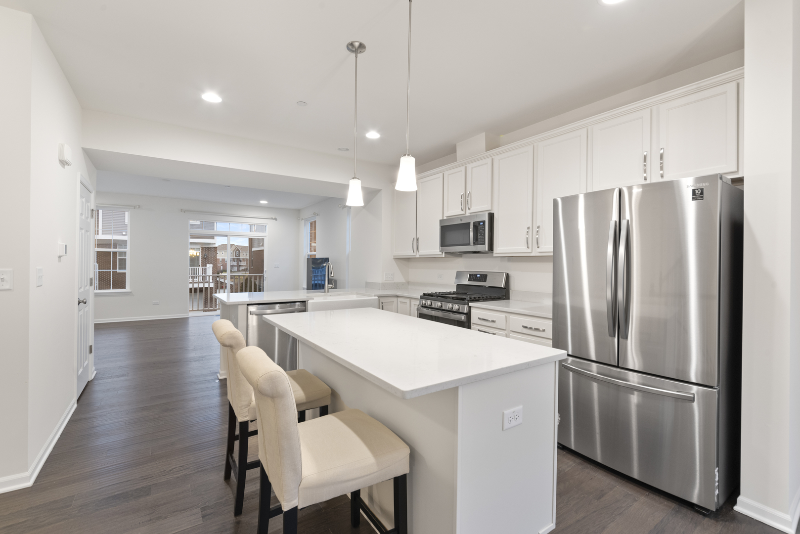4431 Monroe Court Naperville, IL 60564 - Photo 6 of 13 a kitchen with a refrigerator a dining table and chairs