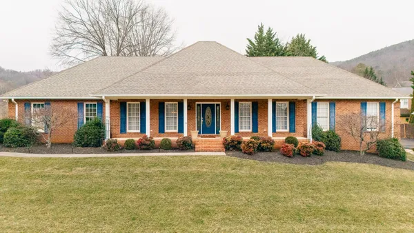 a front view of a house with a garden and porch