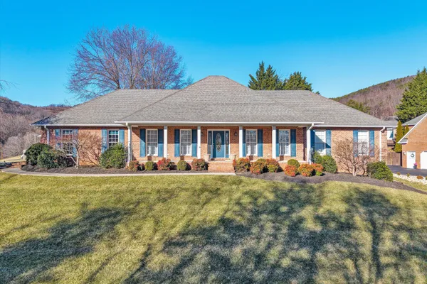 a front view of a house with yard patio and fire pit