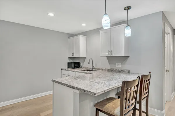 a view of house with backyard and trees
