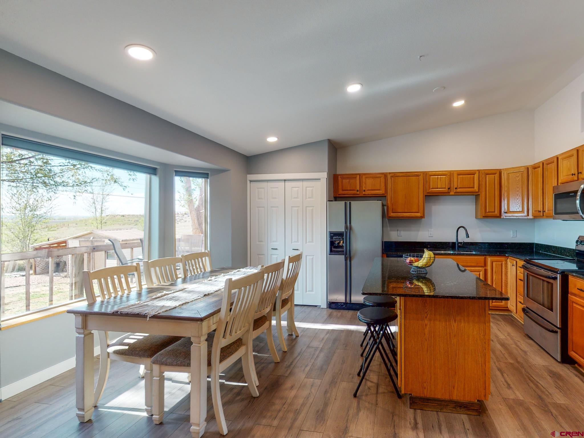 1819 Rolling Road Cortez, CO 81321 - Photo 15 of 35 a view of a dining room with furniture and wooden floor