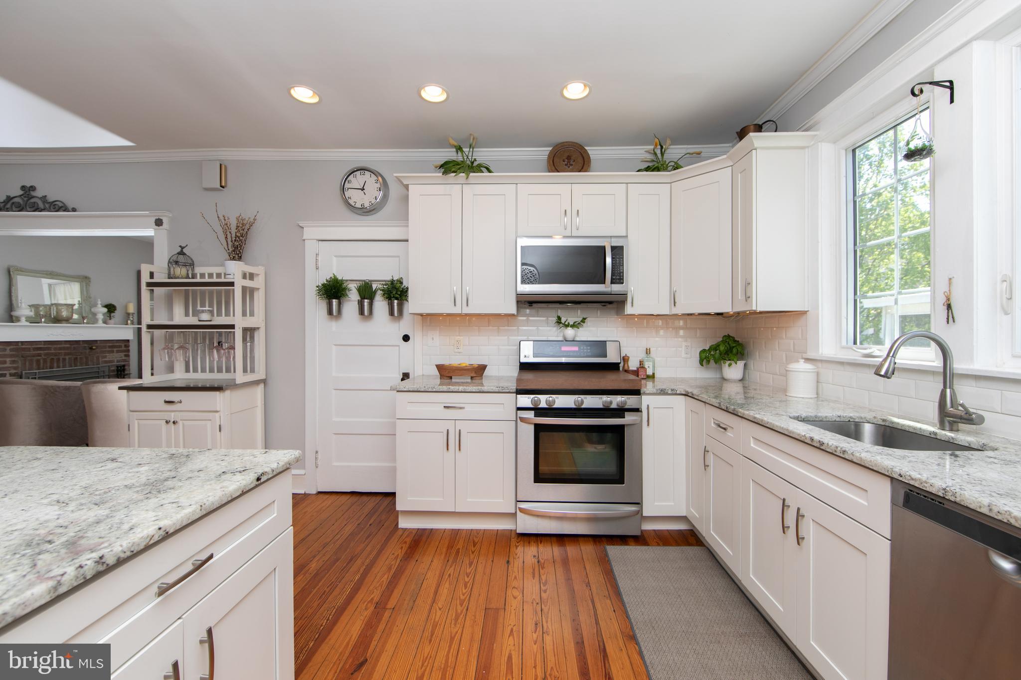 403 Belmont Avenue Haddonfield, NJ 08033 - Photo 18 of 47 a kitchen with kitchen island granite countertop a sink cabinets stainless steel appliances and a window