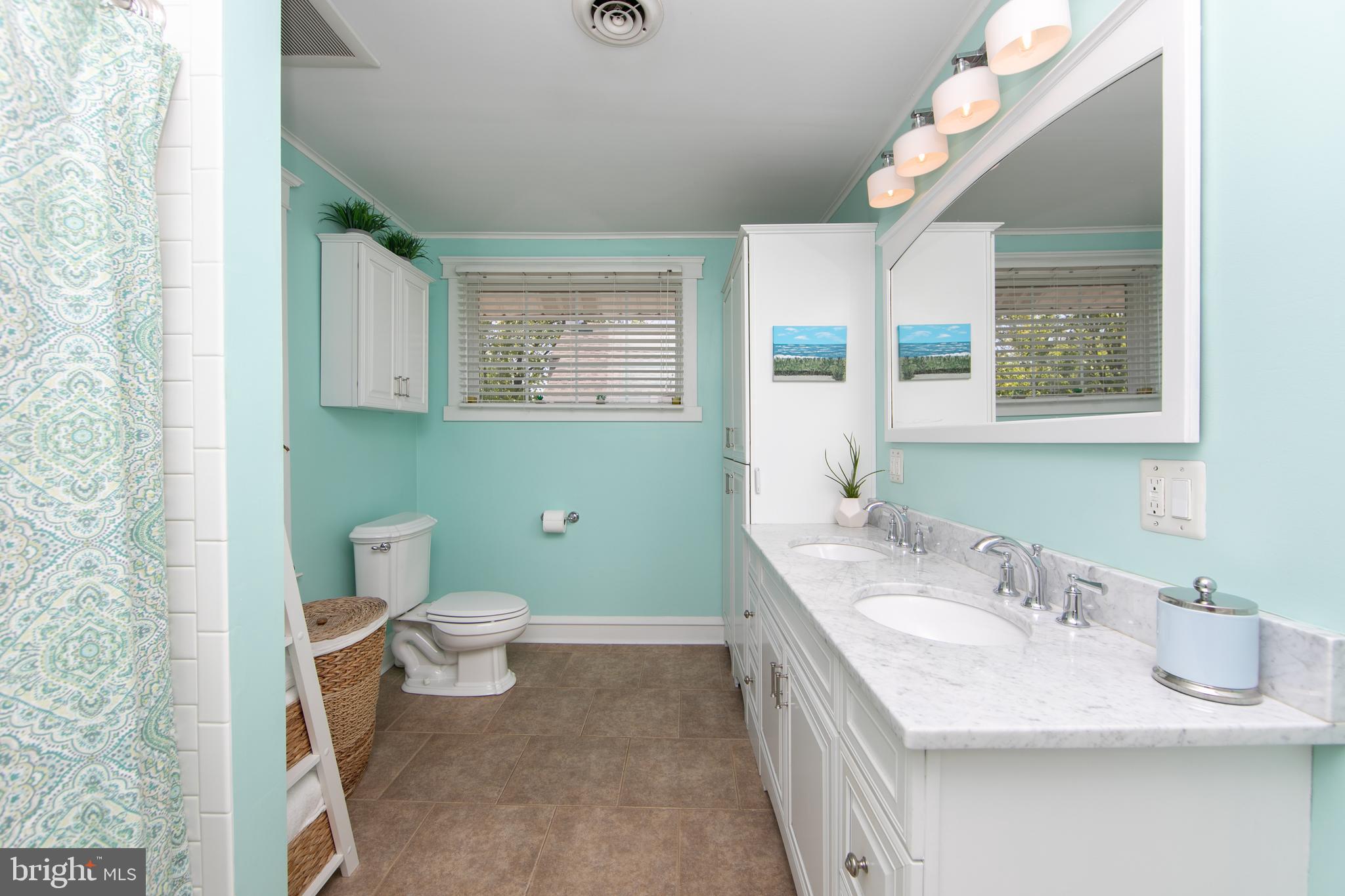 403 Belmont Avenue Haddonfield, NJ 08033 - Photo 35 of 47 a bathroom with a granite countertop toilet sink and mirror