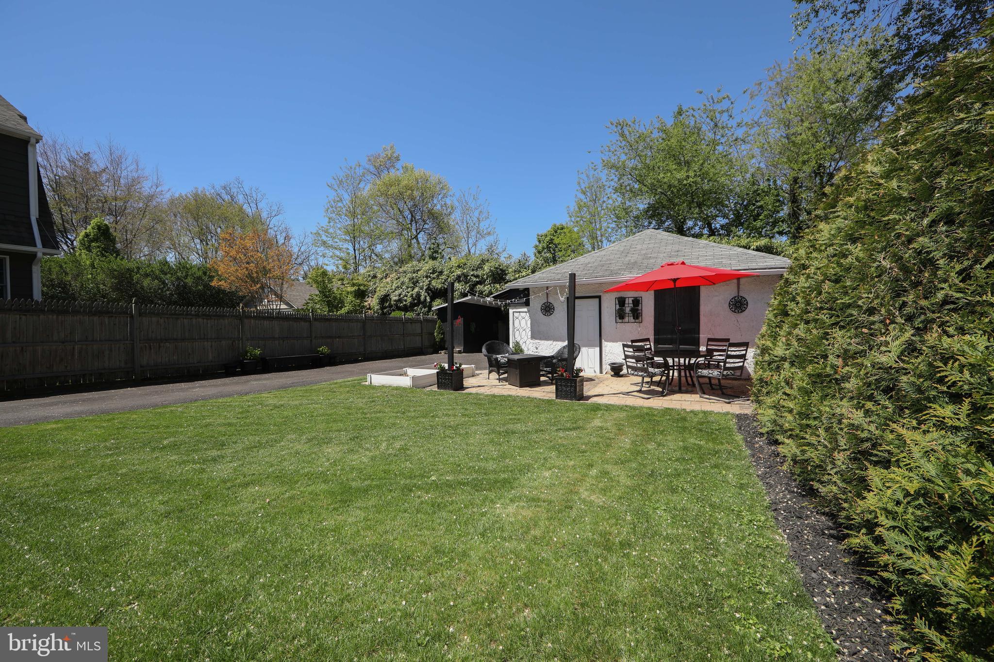 403 Belmont Avenue Haddonfield, NJ 08033 - Photo 47 of 47 a view of a swimming pool with a table and chairs under an umbrella