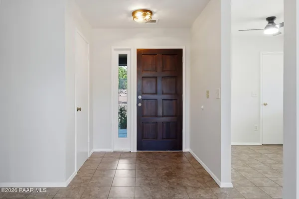 a view of a hallway with wooden shelves