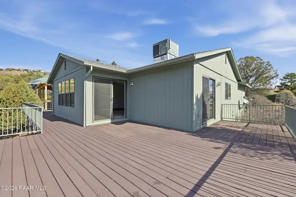 a view of balcony with wooden floor and lake view