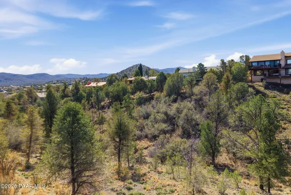 a living room with furniture and a view of kitchen