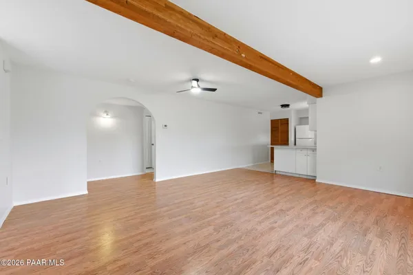 a kitchen with granite countertop a sink and a refrigerator