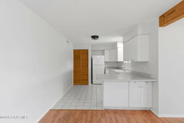 a bedroom with bed and painting on the wall