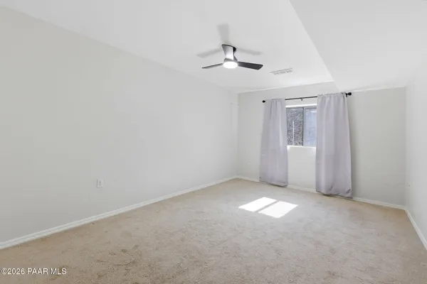 an aerial view of a house with a mountain