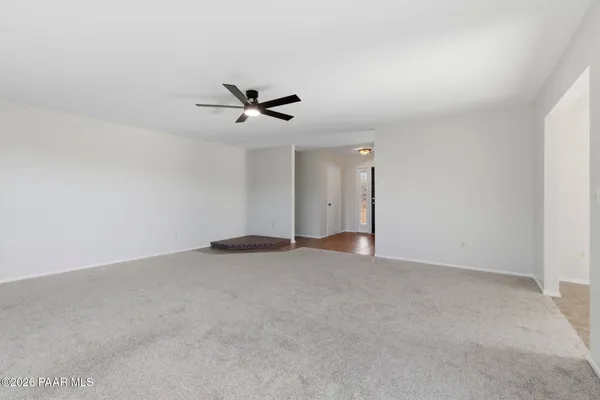 a view of an empty room with a fan