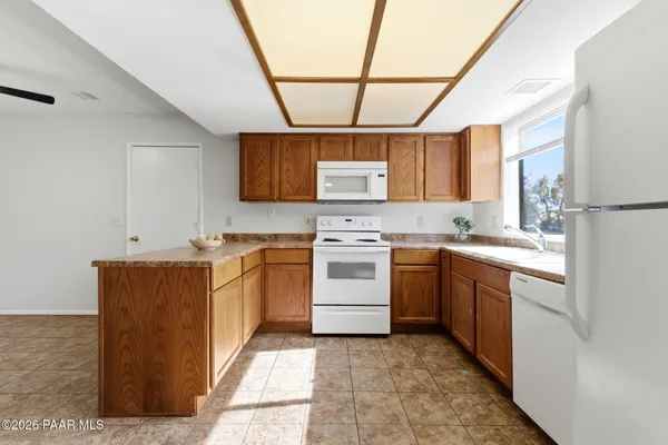 a kitchen with a stove sink and a refrigerator