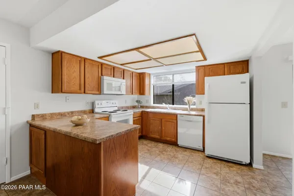 a kitchen with a refrigerator sink stove and cabinets
