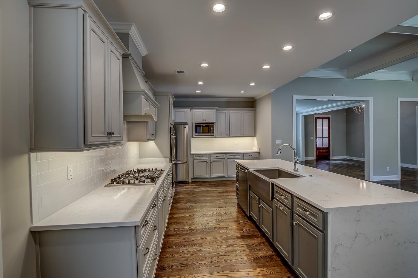 1908 Riverdale Road Germantown, TN 38138 - Photo 10 of 40 Custom cabinetry with Subway tile backsplash at QUARTZ counter tops, barn sink and custom faucet.