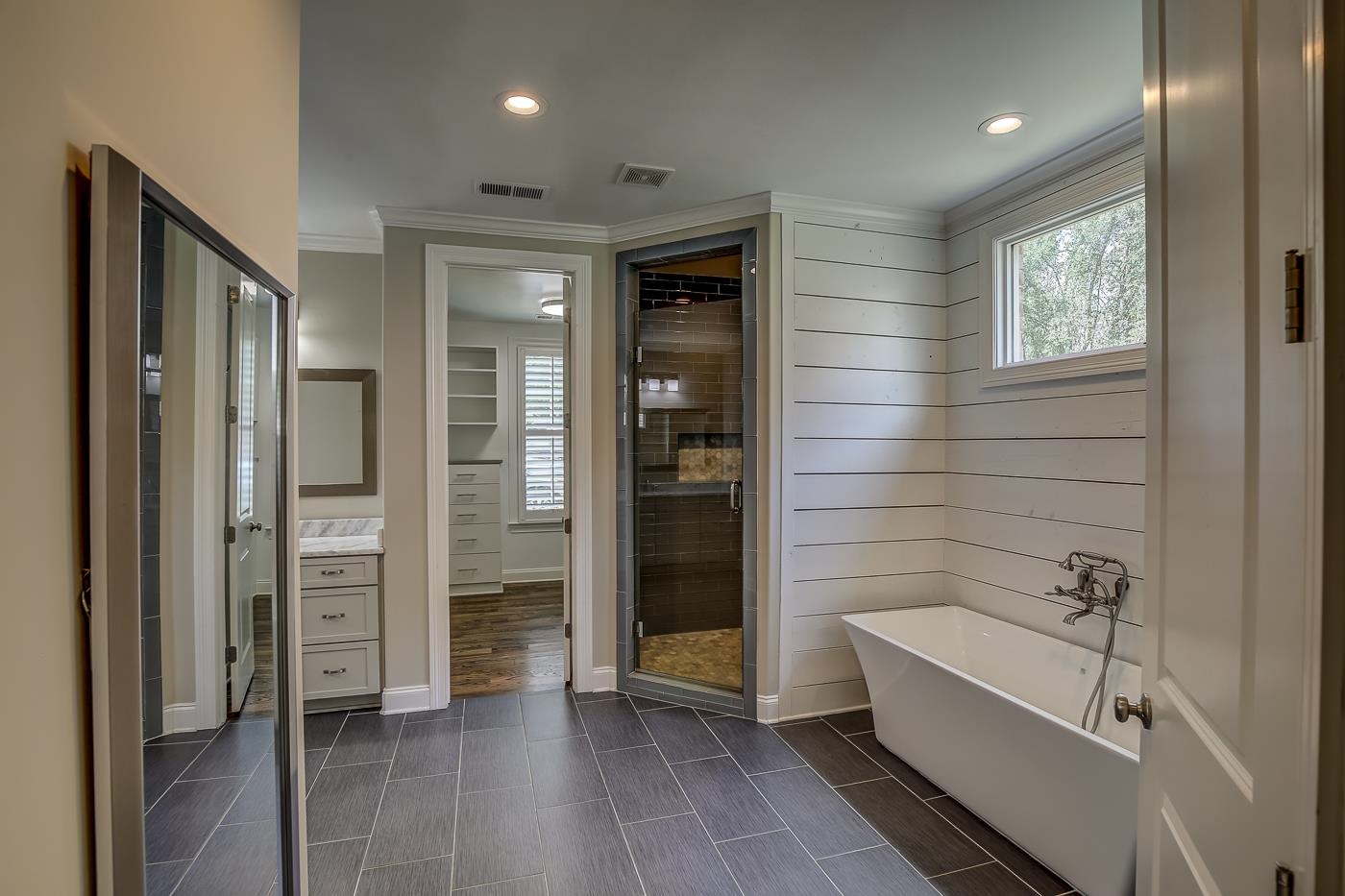1908 Riverdale Road Germantown, TN 38138 - Photo 14 of 40 Custom 1x2 tile floor, Shiplap walls at soaking tub, large shower with floor to ceiling subway tile, mosaic tile floor, frameless glass door and 2 spray nozzles.