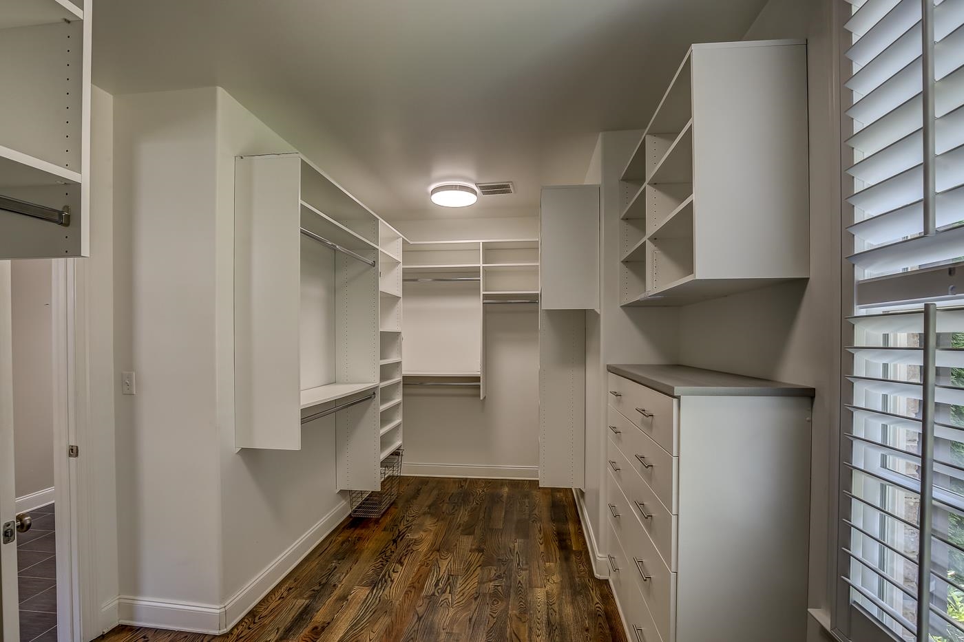1908 Riverdale Road Germantown, TN 38138 - Photo 17 of 40 Spacious closet with hardwood floor and custom built-in cabinets and shelves.