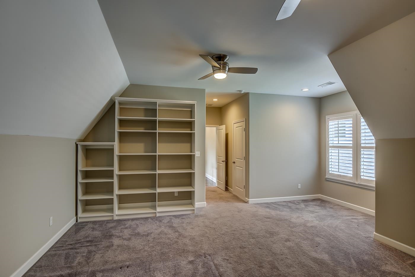 1908 Riverdale Road Germantown, TN 38138 - Photo 23 of 40 2 recessed can lights at dormer window with Plantation Shutters. Built-in shelves. Privacy Bath opposite door to floored attic far right.