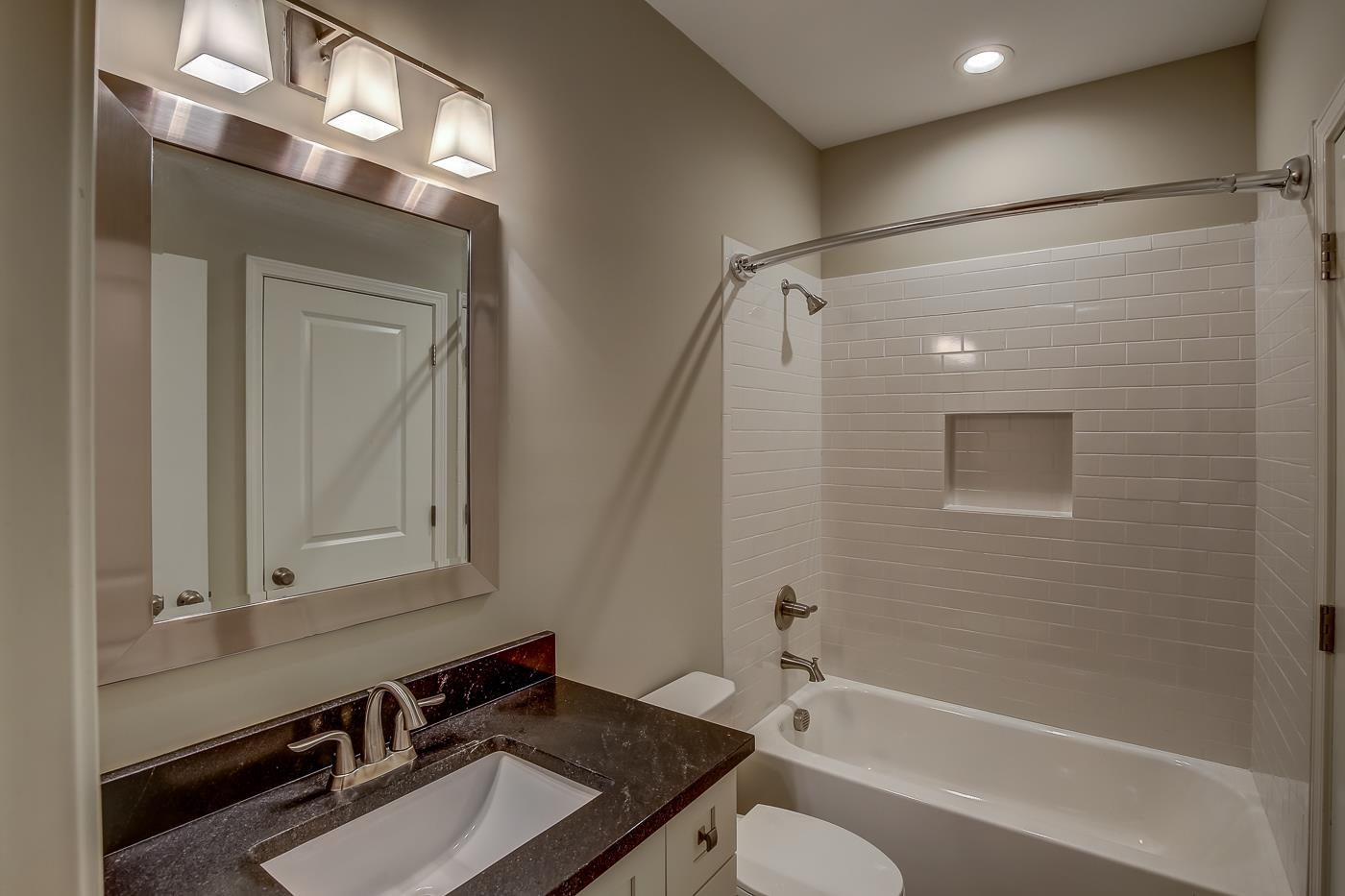 1908 Riverdale Road Germantown, TN 38138 - Photo 27 of 40 Custom tile floor. QUARTZ vanity with 2 drawers. Subway tile shower walls at steel tub.