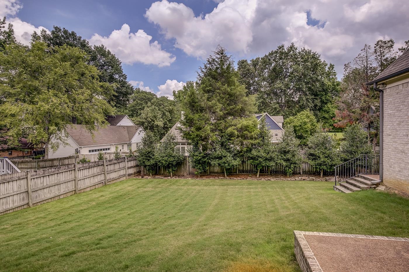 1908 Riverdale Road Germantown, TN 38138 - Photo 37 of 40 Stairway at far right to walkway along garage and gate to driveway.