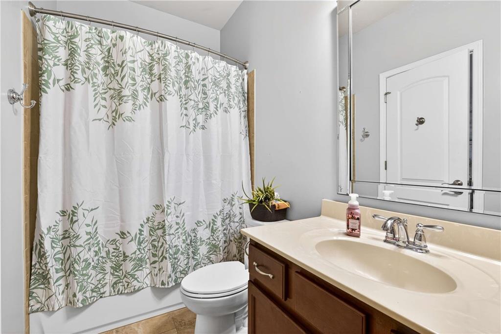 340 Scott Farm Drive Powder Springs, GA 30127 - Photo 32 of 59 a bathroom with a granite countertop sink a toilet and a mirror